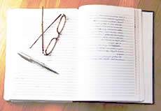 photo of an open journal with eyeglasses and a pen 